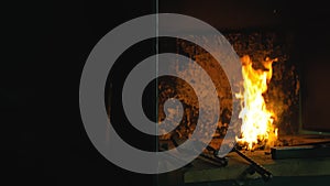 Forge fire in furnace. Blacksmith tempers a steel product in a stove. Smithy forging for hardening and heating iron