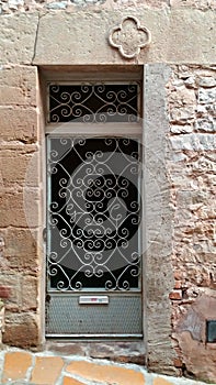 Forged door in an ancient house and town