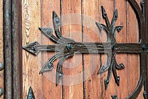 Forged door pattern, decorative. Old vintage entrance, massive heavy wooden door of church or cathedral