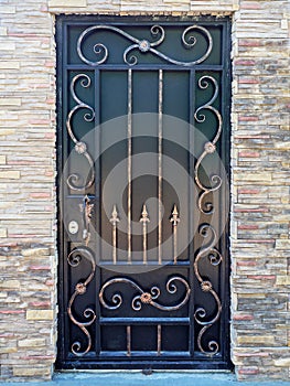 Forged gilded pattern on a black gate. Black gate with forged pattern
