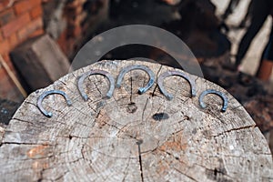 Forged horseshoes on a stump in a forge