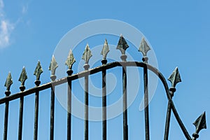 Forged iron fence with arrows on blue sky background in Lisbon, Portugal