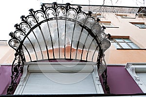 Forged openwork visor of front door of house