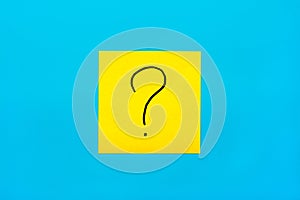 Forget, reminder, combination of colour concept- Close up black handwritten symbol of question mark on one yellow square sticker