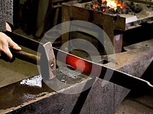 Forging hot iron