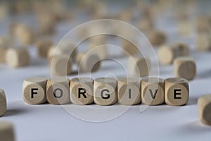 Forgive - cube with letters, sign with wooden cubes
