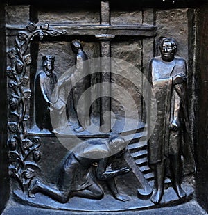 Forgive us our debts - the parable of the unforgiving servant, relief on the door of the Grossmunster church in Zurich