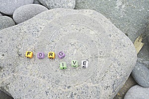 forgive word on pebble stone for background and motivate or multiple concept