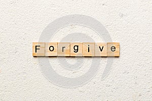 Forgive word written on wood block. Forgive text on cement table for your desing, Top view concept