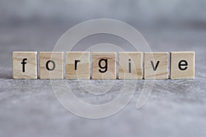 Forgive word written on wood cube