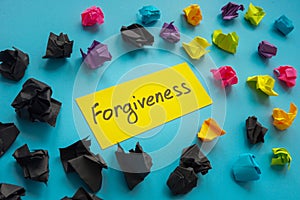 Forgiveness word about relationship and paper balls.