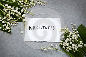 Forgiveness word with white flowers