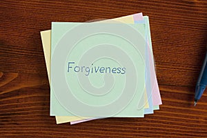 Forgiveness written on a note photo