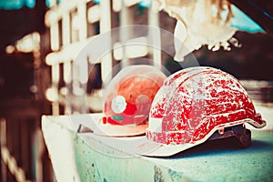 Forgotten builder helmet lying on a concrete block on the blurry background Bridge construction at day light