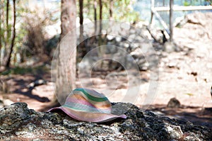 Forgotten colorful Sunhat on a rock