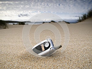 Forgotten mobile phone on the beach