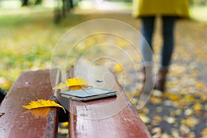 Forgotten smartphone on a park bench