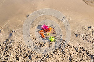 Forgotten toys on a sandy beach