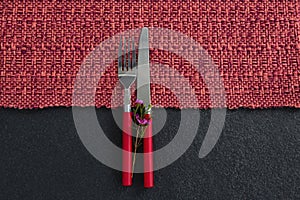 Fork, butter knife with flower on placemat