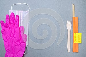 Fork, chopsticks, medical mask, latex gloves and a sticker covid-19 free