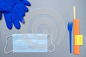 Fork, chopsticks, medical mask, latex gloves and a sticker covid-19 free photo