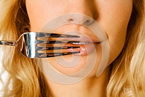 Fork on female mouth