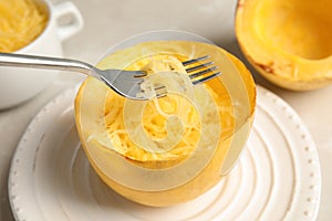 Fork with flesh over cooked spaghetti squash