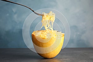 Fork with flesh over cooked spaghetti squash