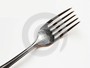 A fork with four tines on a white background