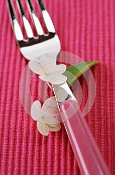 Fork and hydrangea flower