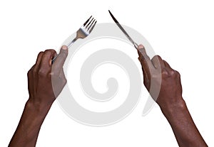 Fork and knife being held by mans hands photo
