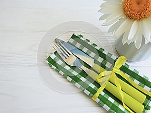 Fork knife chamomile on wooden celebration home dinner