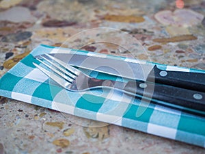 Fork and knife on a napkin. close-up