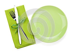 Fork with knife over towel and empty plate
