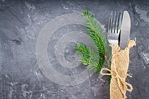 Fork with a knife in the sacking on a gray background