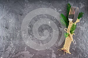 Fork with a knife in the sacking on a gray background
