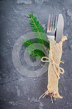 Fork with a knife in the sacking on a gray background