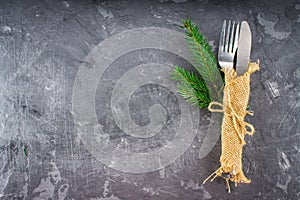 Fork with a knife in the sacking on a gray background