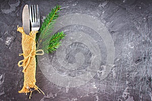Fork with a knife in the sacking on a gray background
