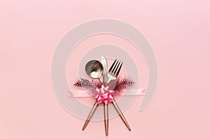 Fork, knife, spoon, silverware with on pink background for catering,