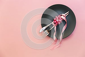 Fork, knife, spoon, silverware with pink on pink background
