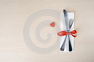 Fork and knife on a tissue near orange knick knack