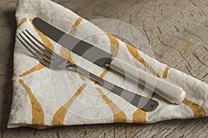 Fork and Knife on White Napkin with Orange Concave Lines