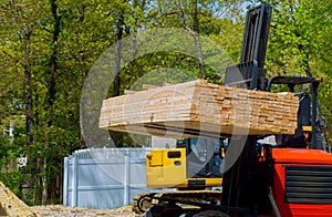 Fork lifter carry construction material beam framework at the building site