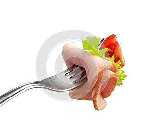 Fork with meat and tomato