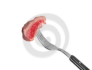 Fork with piece of cooked meat on white background