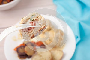 A fork with a piece of a meatball made with ground