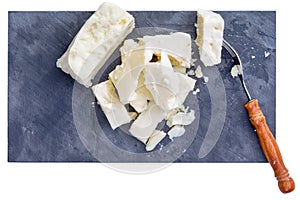 Fork and pieces of white feta cheese