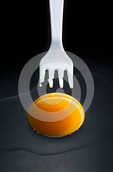 Fork is pricking a egg