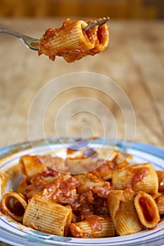 fork with rigatoni pasta with tomato sauce